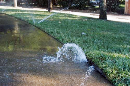 broken-sprinkler-on-driveway